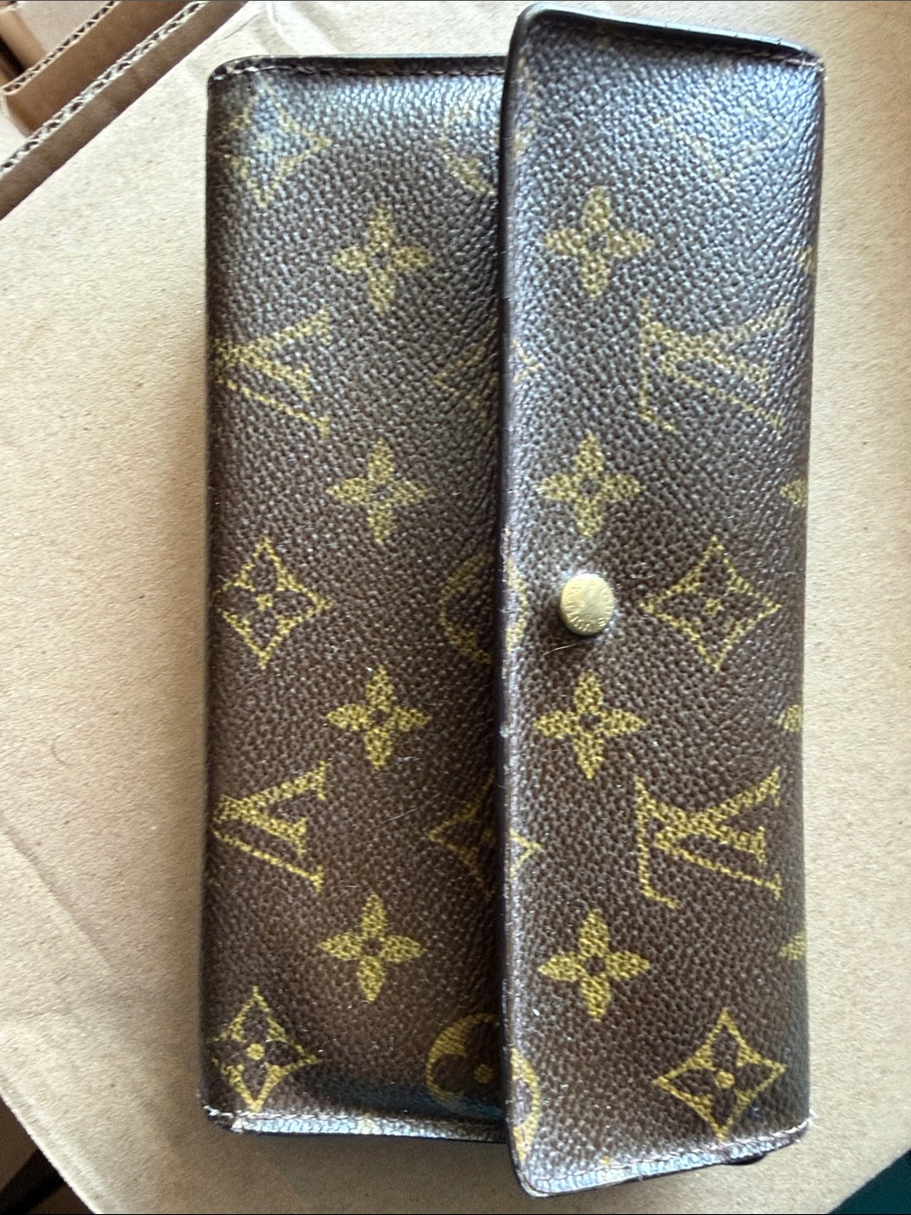 Signature Louis Vuitton Sarah wallet classic monogram canvas.